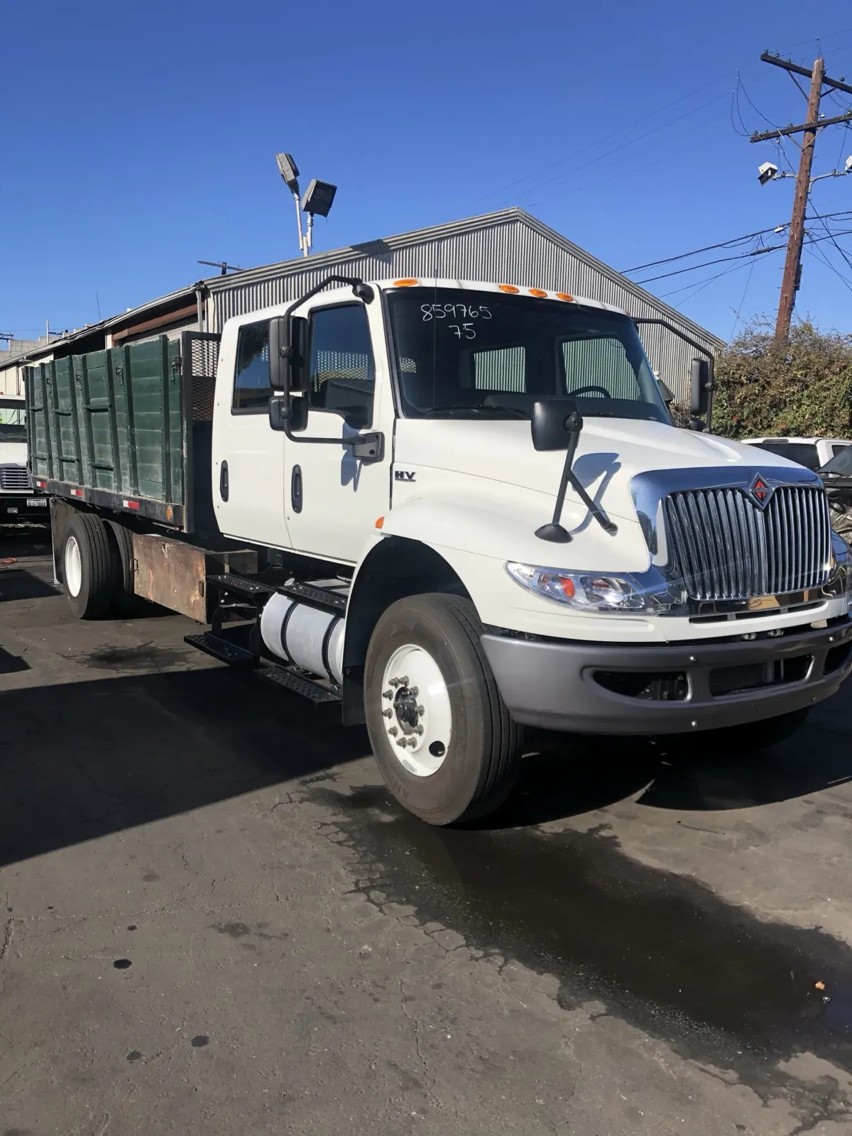 Our crew-cab dump truck with a stake bed at the yard