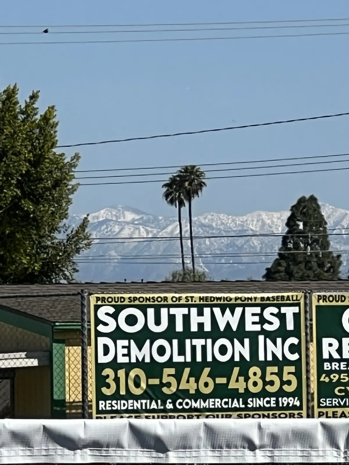 Southwest Demolition banner on the yard fence, residential and commercial since 1994